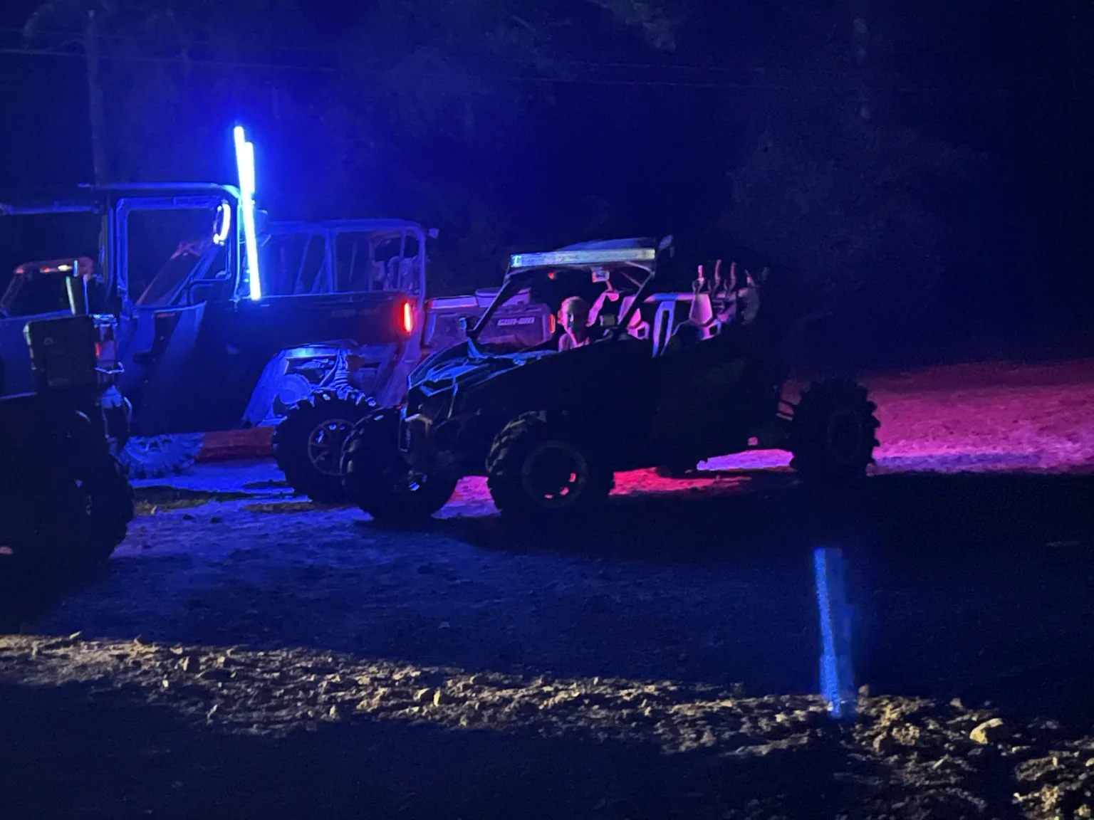 Off-road machine illuminated with custom lights at night